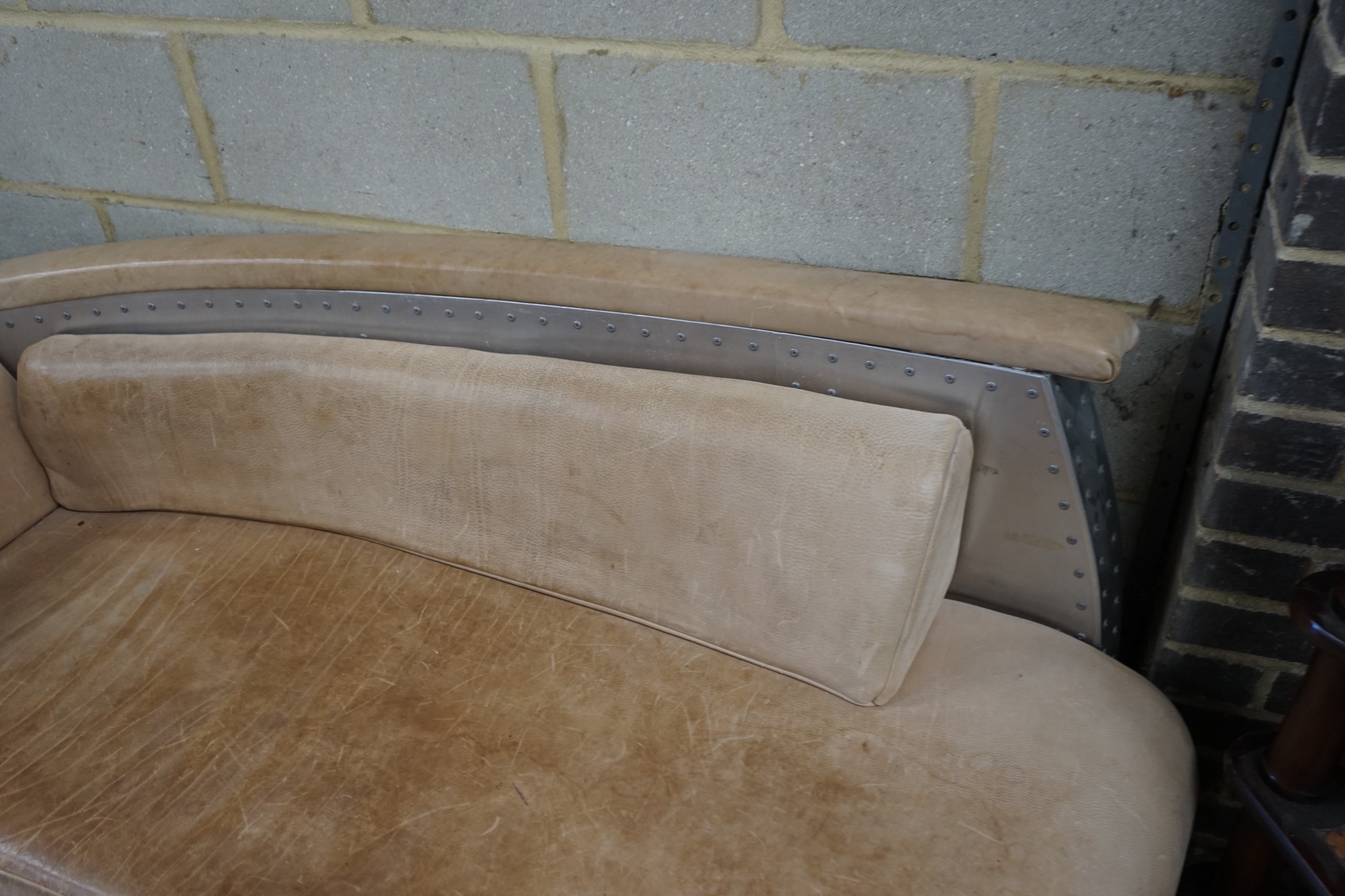 A Timothy Oulton style aluminium and pale brown leather 'Aviator' day bed, length 200cm, width 76cm, height 77cm